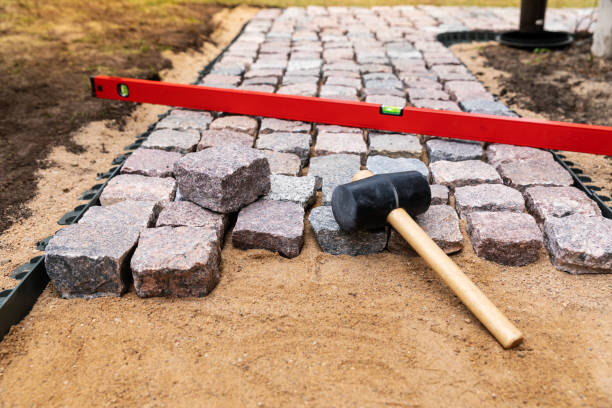 istock garden walkway construction - laying natural granite stone pavers 1142014616