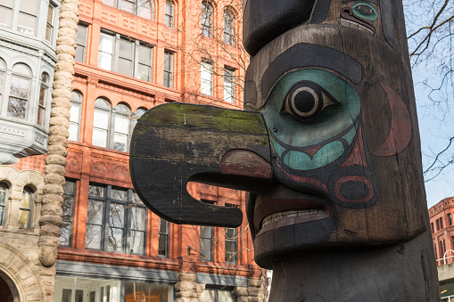 Seattle, Mar 28, 2019: a native american totem pole in pioneer square park late in the day.