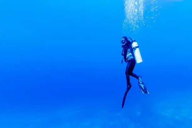 Woman scuba diving in Rangiroa Atoll, French Polynesia