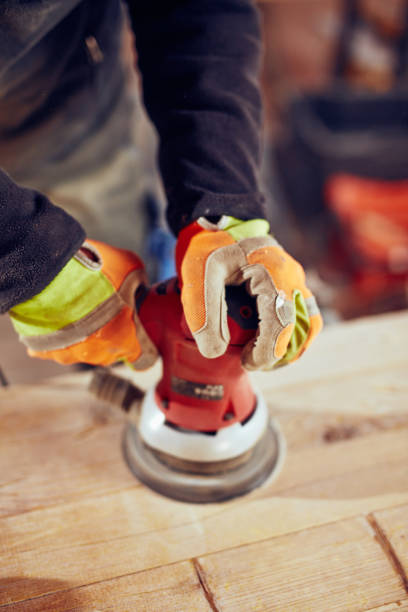 istock Male carpenter using orbital electric sander in a retro vintage workshop. 1142030791