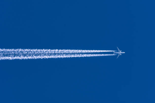 Airplanes leaving contrail trace from left to right on a clear blue sky. Airplanes leaving contrail trace from left to right on a clear blue sky supersonic airplane photos stock pictures, royalty-free photos & images
