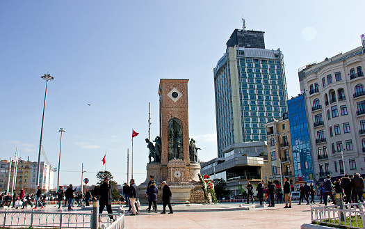 Istanbul, Turkey, February 17, 2019: People walking around Taksim Square in Istanbul. Taksim is the region preferred by tourists at the same time. Thera are istiklal Avenue down the square that known in English as Independence Avenue, the most famous shopping street in the country sees as many as three million pedestrians on a busy weekend day.
