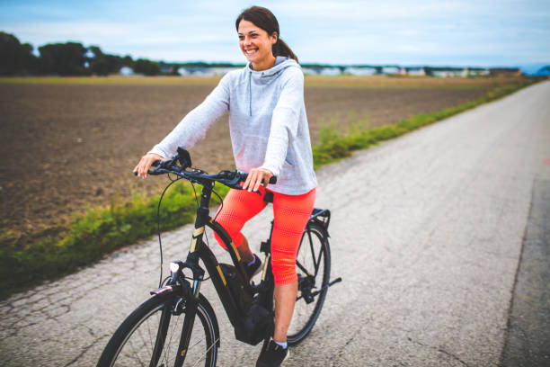 Woman riding on the electric bicycle