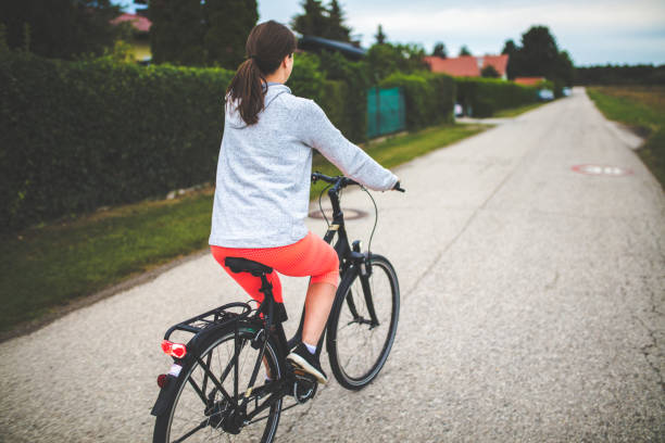 istock Woman riding on her electric bicycle 1142032467