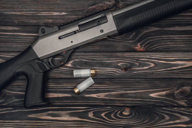 istock Black silver shotgun on a wooden background 1142032701