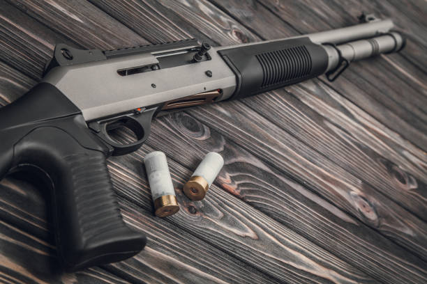 istock Black silver shotgun on a wooden background 1142032767