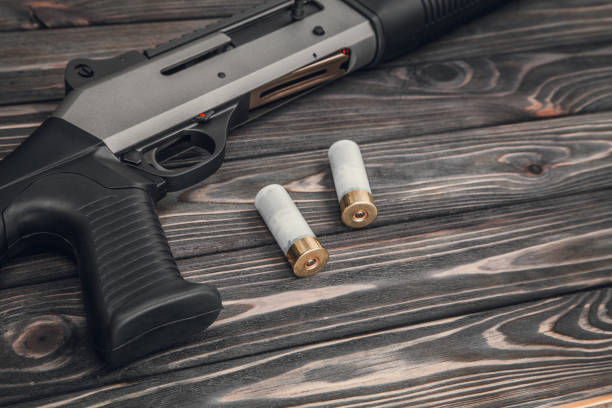 istock Black silver shotgun on a wooden background 1142032791