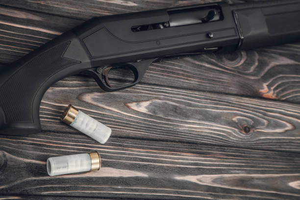 istock Black shotgun on a wooden background 1142032840