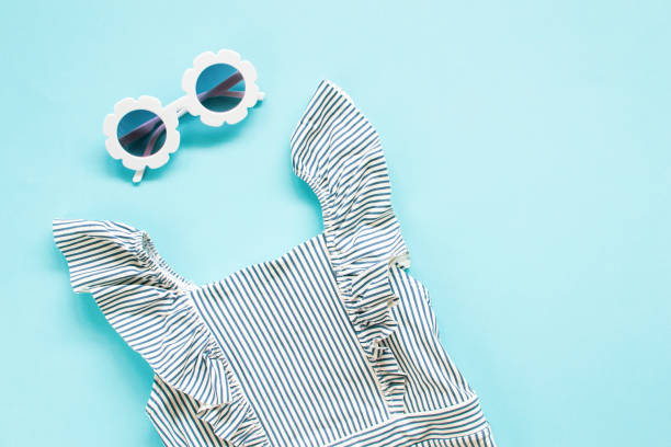istock Composition of white modern sunglasses, tropical leaves on blue background 1142033488