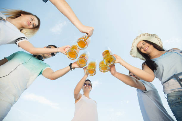 istock Young group people with a beer outdoors 1142033826