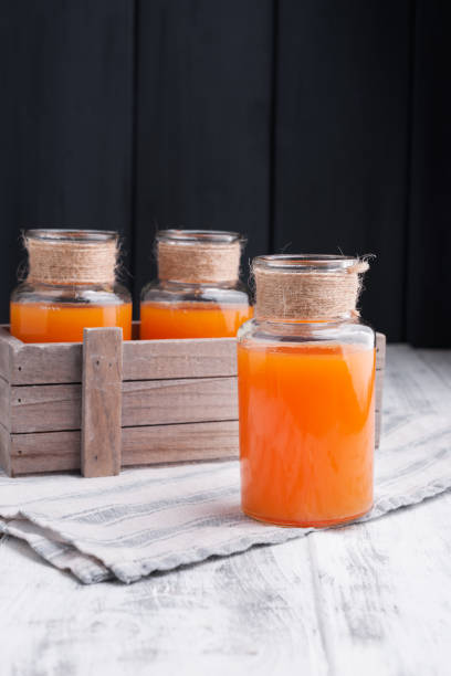 istock Orange juice in a can on a white wooden background. 1142037855