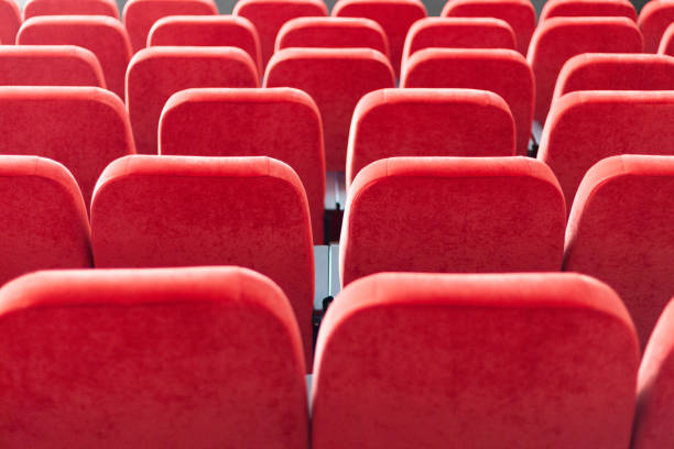 istock red armchairs back view close up. chairs at conference hall. pattern background. 1142041460
