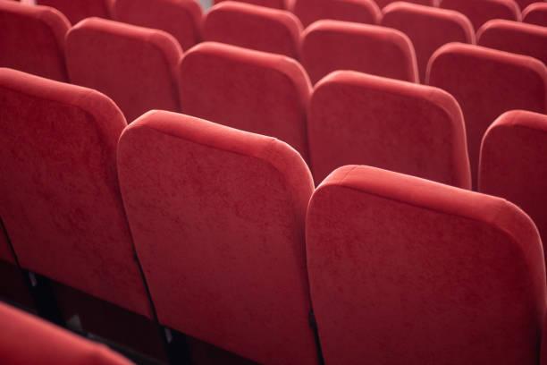 istock red armchairs close up. chairs at conference hall. pattern background. 1142041552