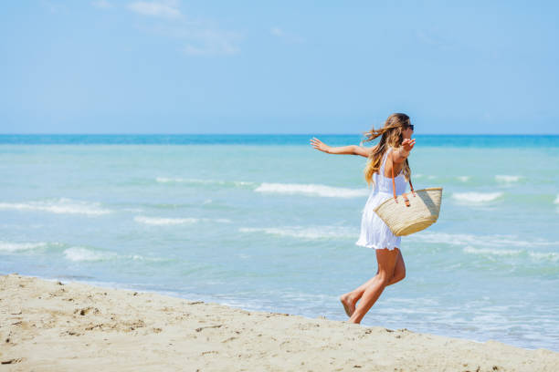 istock Happy Girl having fun on tropical beach 1142043836