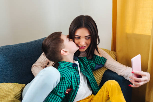 istock Mother and her little son making selfie at home 1142048377