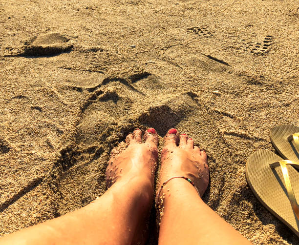 Sunbathing, feet on the beach, vacation