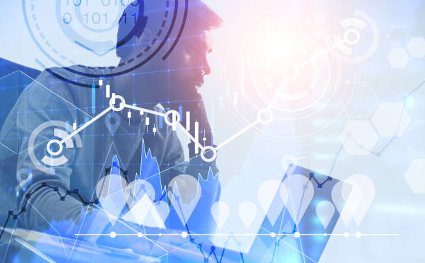 istock Serious businessman with laptop, graphs and hud 1142055730