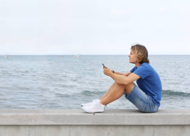 istock Teenage boy typing text message.Using smart phone. 1142056156