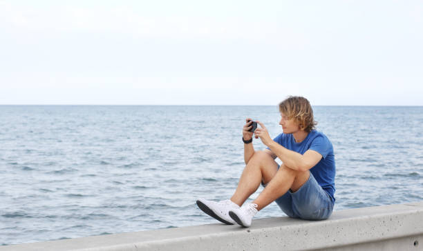 istock Teenage boy typing text message.Using smart phone. 1142056159