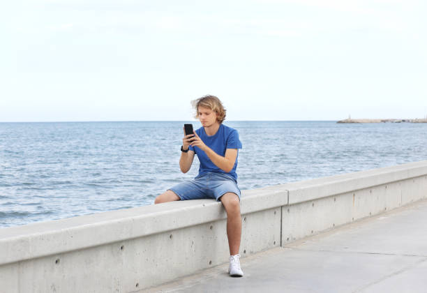 istock Teenage boy typing text message.Using smart phone. 1142056174