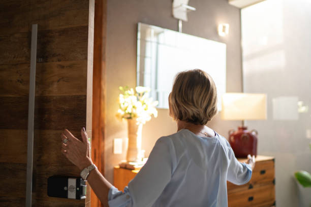 istock Mature woman opening door 1142064220
