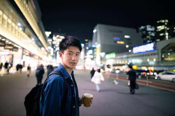 istock Teenage boy visiting Tokyo at night 1142067973