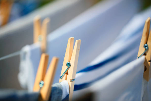 Many wooden clothespins on a rope close-up