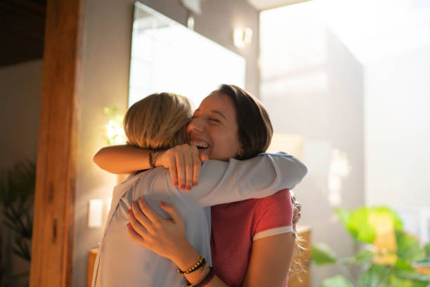 Teenagr girl and mature woman embracing Hugging reunion stock pictures, royalty-free photos & images