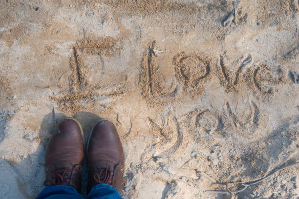 istock phrase i love you written in the sand 1142090721