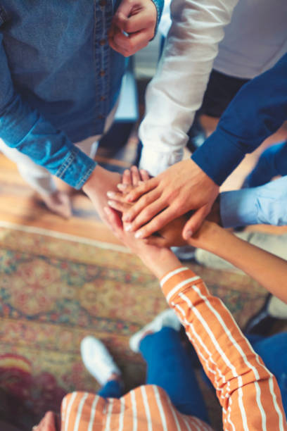 istock Group of workers holding hands in celebration. Collaboration concept. 1142090757