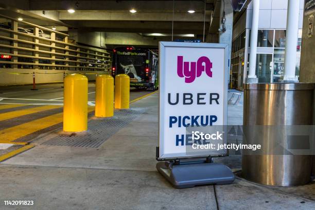Ride Sharing Companies Lyft And Uber Pickup Spot At The Airport Lyft And Uber Have Replaced Many Taxi Cabs For Transportation I Stock Photo - Download Image Now