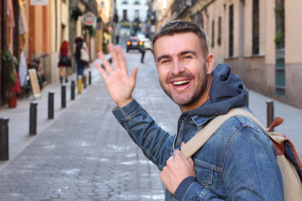 istock Man saluting someone he knows outdoors 1142094019