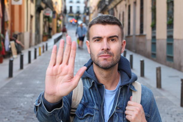 istock Man showing a STOP hand sign 1142094031
