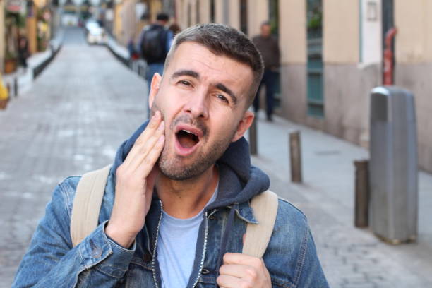 Unhappy man suffering from bruxism Unhappy man suffering from bruxism. clenching teeth stock pictures, royalty-free photos & images