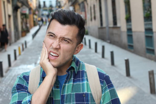 Unhappy man suffering from bruxism stock photo