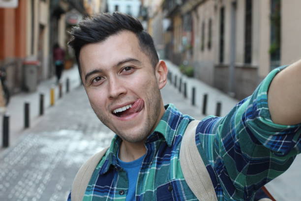 istock Attractive young man taking a funny selfie 1142094095