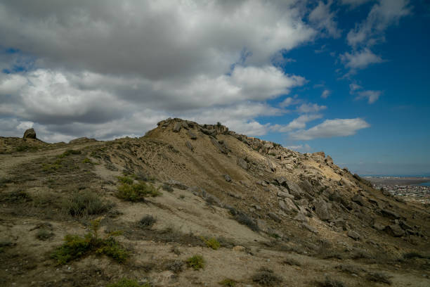 istock Hill with rocks against the sky with white clouds. 1142096080