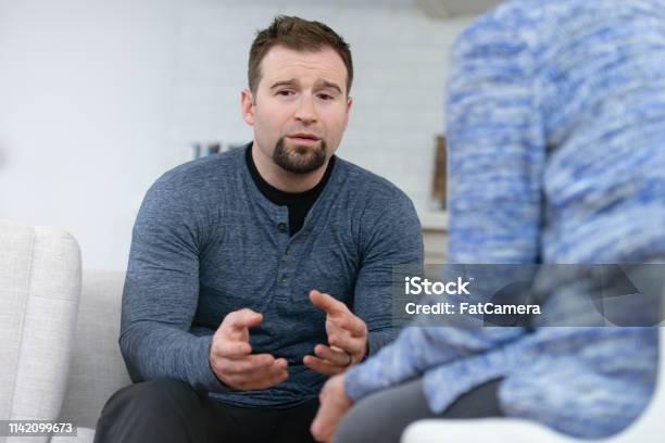 Upset Man In Therapy Stock Photo - Download Image Now - Discussion, Psychotherapy, Men