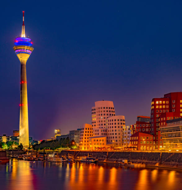 Colorful night scene of Rhein river at night in Dusseldorf. Colorful night scene of Rhein river at night in Dusseldorf. Media Harbor in the soft night light, Nordrhein-Westfalen, Germany, Europe media harbor photos stock pictures, royalty-free photos & images
