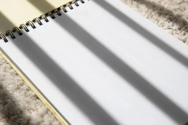 Photo of Musical note book on white carpet background