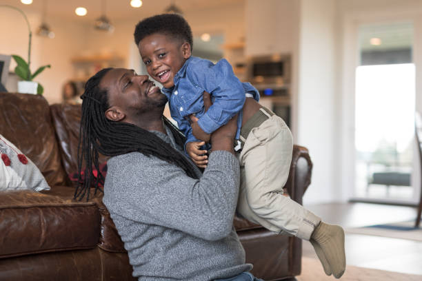 istock Young African American boy wrestling with dad 1142103299