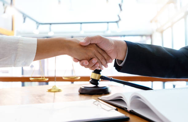 Lawyer or judge  with gavel and balance handshake with client Lawyer or judge  with gavel and balance handshake with client or customer about agreement how to  use arbitration       handshake mediation photos stock pictures, royalty-free photos & images