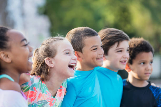 istock Girl standing with multi-ethnic friends, laughing 1142108274