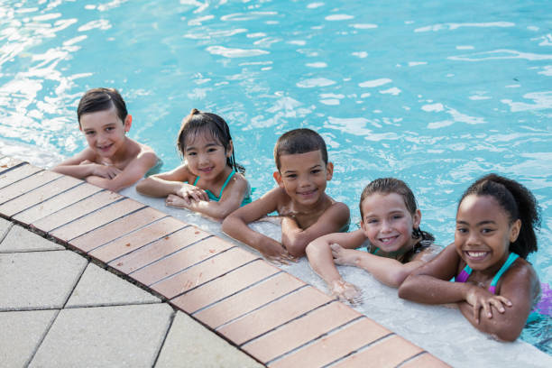 istock Five multi-ethnic children having fun in swimming pool 1142108392
