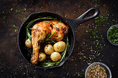 Chiken leg and potatoes in a skillet