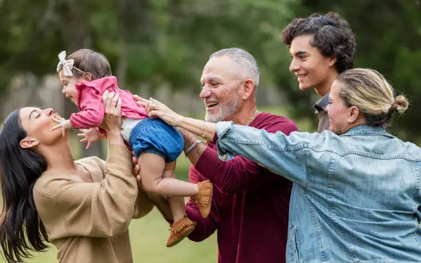 Photo of Multi-generation Hispanic family, mother holding baby