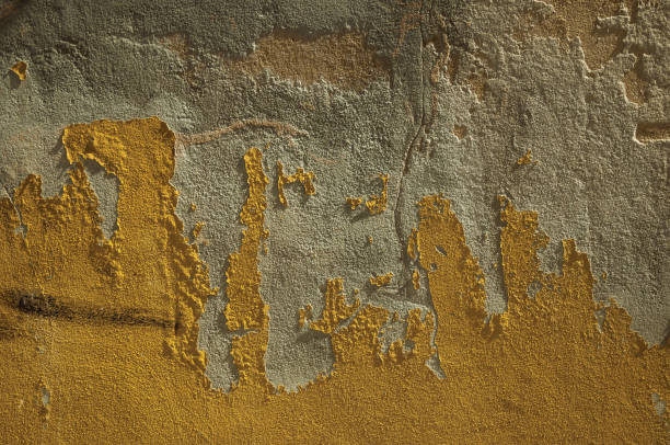 istock Plaster peeling off an old wall forming a quaint background 1142112047