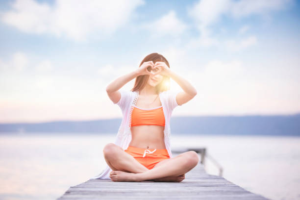 istock Woman making heart shape with hands in summer 1142113193