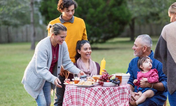 istock Multi-generation Hispanic family having backyard cookout 1142113262