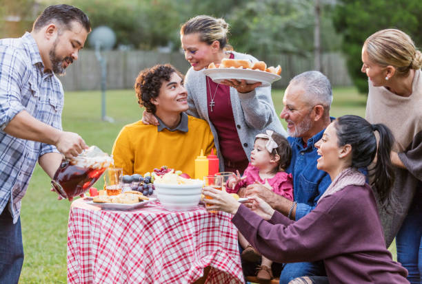 istock Multi-generation Hispanic family having backyard cookout 1142113265